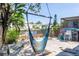 Backyard featuring a hammock swing, trees, a canal and seating, perfect for relaxing outdoors at 5824 Portsmouth Dr, Tampa, FL 33615