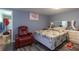 Bedroom featuring a red recliner and comfy bed, illuminated by natural light at 5824 Portsmouth Dr, Tampa, FL 33615