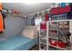 Cozy bedroom with a twin bed, storage shelves, and personal items neatly arranged at 5824 Portsmouth Dr, Tampa, FL 33615