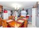 Dining room with a large wooden table set for a meal, adjacent to the kitchen area at 5824 Portsmouth Dr, Tampa, FL 33615