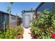 Charming walkway lined with vibrant roses leading to the entrance with a secure gate at 5824 Portsmouth Dr, Tampa, FL 33615