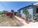 Home exterior features colorful roses, and a walkway, enhancing the curb appeal at 5824 Portsmouth Dr, Tampa, FL 33615