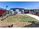 Charming home with a well-maintained lawn, mature landscaping and convenient carport space at 5824 Portsmouth Dr, Tampa, FL 33615