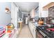 Galley kitchen with tile flooring, white cabinets, granite countertops, and stainless steel appliances at 5824 Portsmouth Dr, Tampa, FL 33615