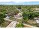This aerial view features a fenced yard and mature trees surrounding the home at 6019 Wyoming Ave, New Port Richey, FL 34653