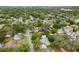 A neighborhood aerial view showcases tree coverage, residential streets, and varying home styles at 6019 Wyoming Ave, New Port Richey, FL 34653