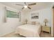 This bedroom features tile floors, ceiling fan and a window for natural light at 6019 Wyoming Ave, New Port Richey, FL 34653