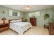 Cozy bedroom featuring comfortable furnishings and two sunny windows at 6019 Wyoming Ave, New Port Richey, FL 34653
