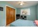 Relaxing bedroom features a closet, a ceiling fan, and large window at 6019 Wyoming Ave, New Port Richey, FL 34653