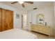 A well lit bedroom featuring tile floors and an ensuite bathroom at 6019 Wyoming Ave, New Port Richey, FL 34653