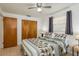 Warm bedroom features wooden closets and natural lighting from the window at 6019 Wyoming Ave, New Port Richey, FL 34653