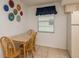 Dining area featuring tile floors, a dining table, and a window providing natural light at 6019 Wyoming Ave, New Port Richey, FL 34653