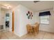 Eat-in kitchen with tile floors, a dining table, and a window with a blue valence at 6019 Wyoming Ave, New Port Richey, FL 34653