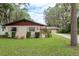 A well-maintained home with a lush front lawn, mature trees, and beautiful landscaping at 6019 Wyoming Ave, New Port Richey, FL 34653