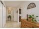 Bright hallway with tiled floors, decorative furniture, and access to multiple rooms at 6019 Wyoming Ave, New Port Richey, FL 34653