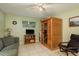 A cozy living room includes a sauna, entertainment center, comfortable seating, and ample light at 6019 Wyoming Ave, New Port Richey, FL 34653