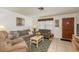 Cozy living room featuring comfortable seating, tile floors and lots of natural light at 6019 Wyoming Ave, New Port Richey, FL 34653