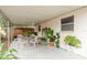 Covered patio with seating area and lush landscaping provides an outdoor living space at 6019 Wyoming Ave, New Port Richey, FL 34653