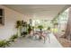 Covered patio with seating area and lush landscaping provides an outdoor living space at 6019 Wyoming Ave, New Port Richey, FL 34653