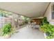 Covered patio with seating area and lush landscaping provides an outdoor living space at 6019 Wyoming Ave, New Port Richey, FL 34653