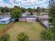 Overhead view showcases fenced backyard, lush grass, and a cozy home in a charming neighborhood at 6341 Hyperion Dr, Port Richey, FL 34668