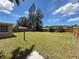Expansive backyard featuring a grassy area, enclosed by a wood fence, offering privacy and space at 6341 Hyperion Dr, Port Richey, FL 34668