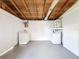 Unfinished basement with white washer and dryer at 6341 Hyperion Dr, Port Richey, FL 34668