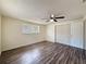 Bedroom featuring wood floors, a ceiling fan, a window, and a closet at 6341 Hyperion Dr, Port Richey, FL 34668
