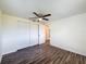 Bedroom showcasing wood floors, a ceiling fan, and closet space at 6341 Hyperion Dr, Port Richey, FL 34668