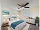 Comfortable bedroom with a ceiling fan, stylish furnishings, and natural light at 6341 Hyperion Dr, Port Richey, FL 34668