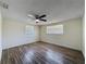 Bedroom featuring dual windows and wood floors with a ceiling fan at 6341 Hyperion Dr, Port Richey, FL 34668