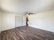 Spacious bedroom with wood-look floors, ceiling fan and closet provides ample storage at 6341 Hyperion Dr, Port Richey, FL 34668