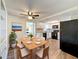 Dining area with wood floors and a view of the kitchen adds to the charm of the space at 6341 Hyperion Dr, Port Richey, FL 34668