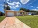 Inviting single-Gathering home with manicured lawn, charming facade, and attached garage on a sunny day at 6341 Hyperion Dr, Port Richey, FL 34668