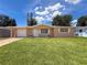 Charming single-story home featuring a well-maintained lawn and attached garage under a sunny blue sky at 6341 Hyperion Dr, Port Richey, FL 34668