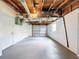 Spacious garage with overhead storage and white walls at 6341 Hyperion Dr, Port Richey, FL 34668