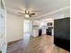 Kitchen featuring black appliances, white cabinets, tile backsplash, and wood flooring at 6341 Hyperion Dr, Port Richey, FL 34668