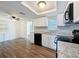 Bright kitchen featuring white cabinetry, modern appliances and durable wood look flooring at 6341 Hyperion Dr, Port Richey, FL 34668