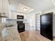 Modern kitchen with granite countertops, stainless steel appliances, and ample storage space at 6341 Hyperion Dr, Port Richey, FL 34668