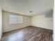 Spacious living room featuring wood floors, a large window, and a bright and airy feel at 6341 Hyperion Dr, Port Richey, FL 34668