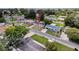 Neighborhood view of the home with a long driveway, surrounded by other cozy homes and greenery at 6341 Hyperion Dr, Port Richey, FL 34668