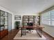 Office with a large desk, built-in shelves, and lots of natural light at 6341 Hyperion Dr, Port Richey, FL 34668