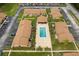Overhead view of the community pool area with surrounding apartment buildings and ample parking at 7122 Barclay Ave # B, Spring Hill, FL 34609