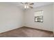 Bedroom featuring carpet, a ceiling fan, and a window overlooking a sunny landscape at 7122 Barclay Ave # B, Spring Hill, FL 34609