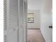 Bedroom with carpet, a ceiling fan, a window, and a closet with folding doors at 7122 Barclay Ave # B, Spring Hill, FL 34609