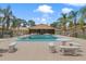 Refreshing community pool with lounge seating and palm tree accents at 7122 Barclay Ave # B, Spring Hill, FL 34609