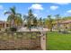 View of the community pool area surrounded by lush landscaping and palm trees at 7122 Barclay Ave # B, Spring Hill, FL 34609