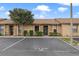 Charming condo featuring stone accents, mature landscaping, and assigned parking at 7122 Barclay Ave # B, Spring Hill, FL 34609