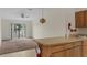 Open concept kitchen features a breakfast bar and seamless connection to the living area at 7122 Barclay Ave # B, Spring Hill, FL 34609