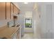 Efficient kitchen features a window, a stove, and bright white appliances at 7122 Barclay Ave # B, Spring Hill, FL 34609